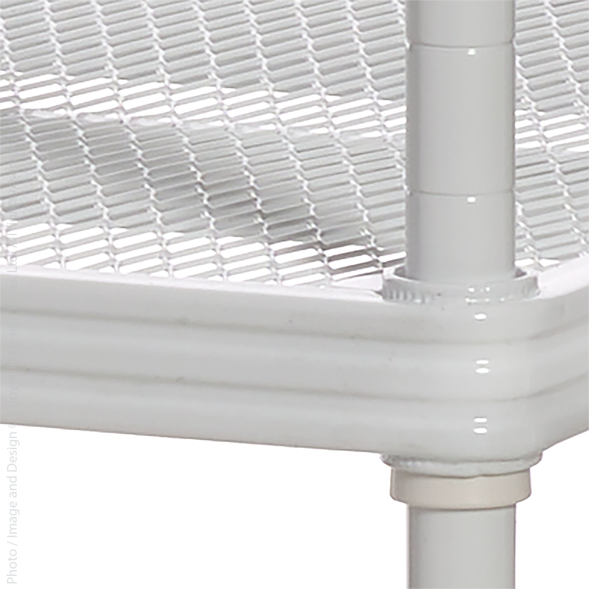 Close-up of shelf corner and mesh surface
